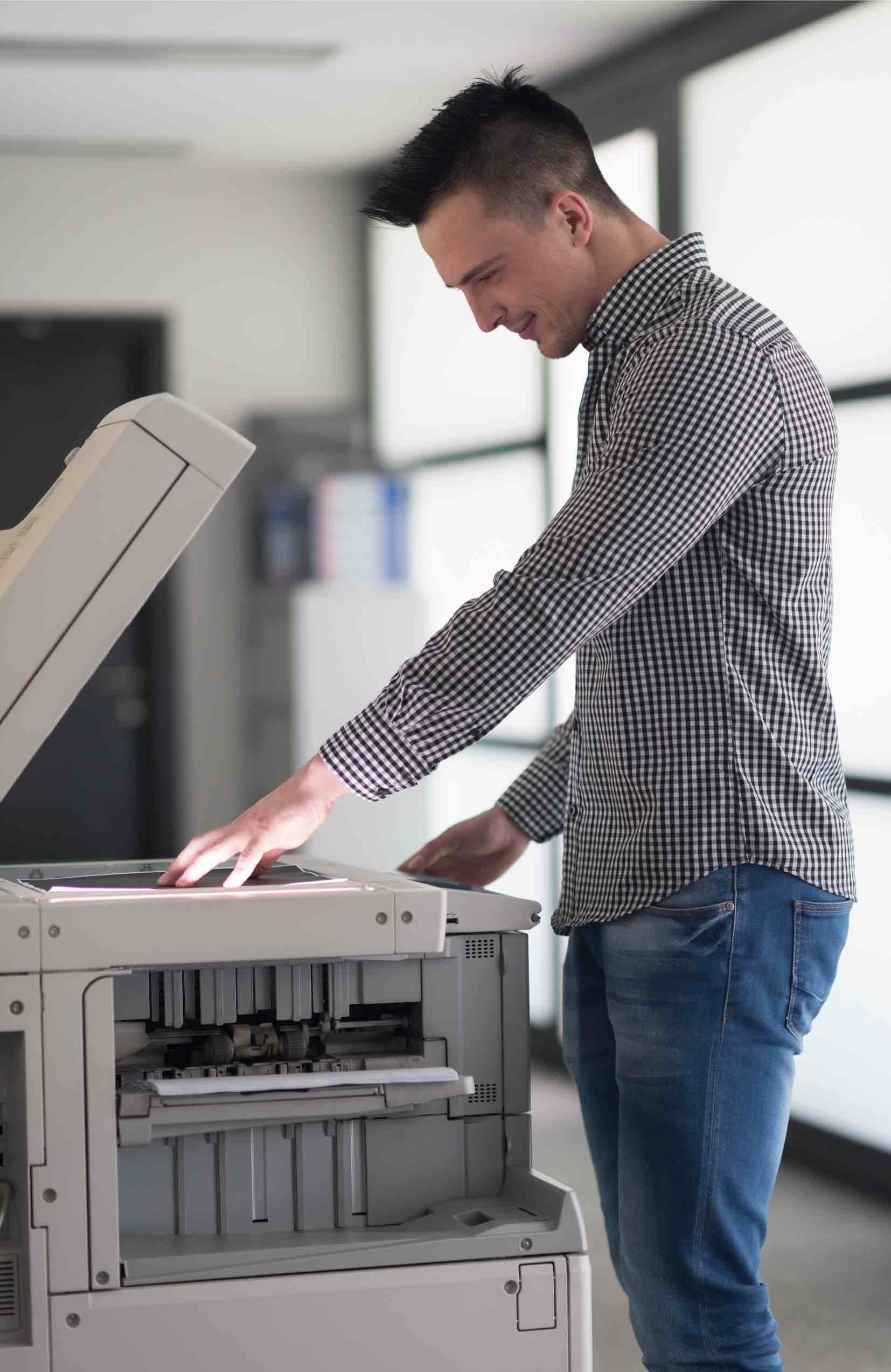 This man scans documents to get his small business go paperless thanks to tips from Paramount Tax & Accounting Springville.